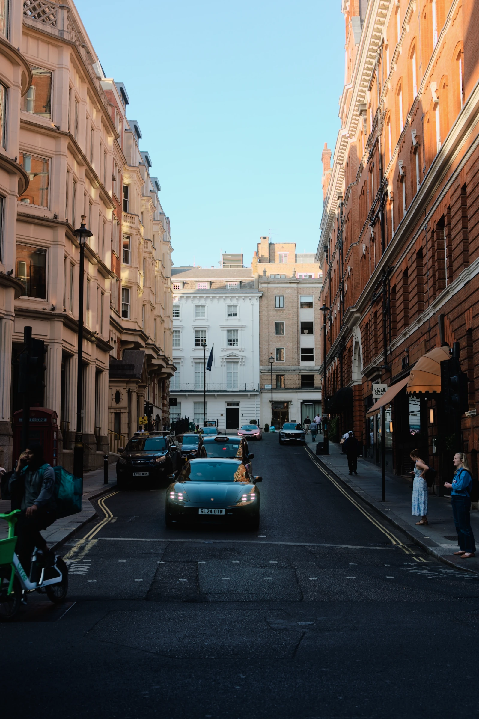 Warm light on the buildings above a shaded street